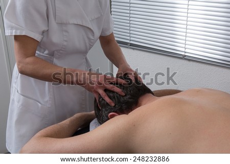 A woman spirit healer doing reiki treatment to a man