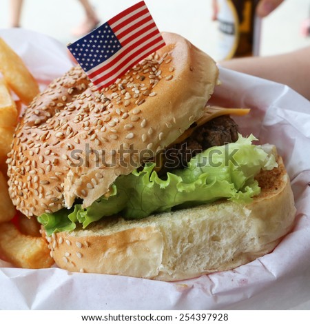 Delicious hamburger stacked high with a juicy beef patty,  fresh lettuce,