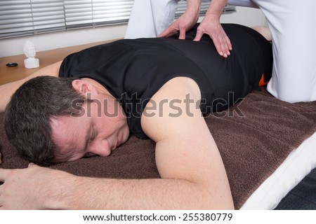 Man and woman performing back shiatsu massage