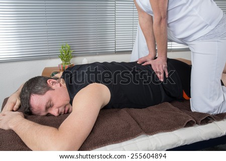 One man and woman performing back  massage