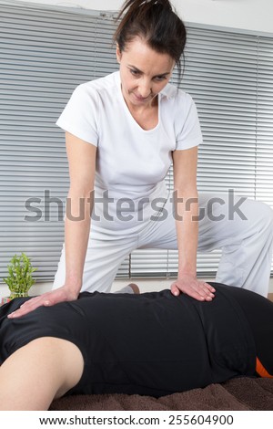 Man and woman performing back shiatsu massage