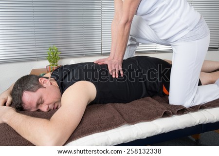 One man and woman performing shiatsu  massage