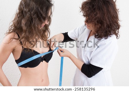 Slim woman being measured with tape measure in centimeters