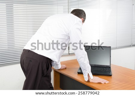 Businessman standing posture hand hold notebook laptop