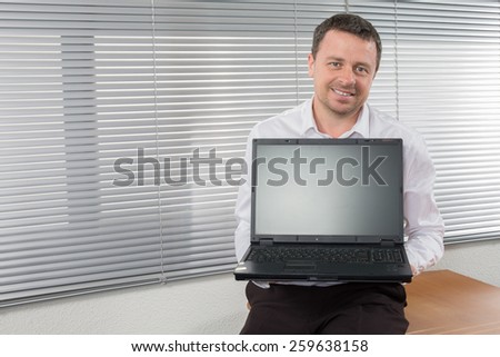Businessman standing posture hand hold notebook laptop