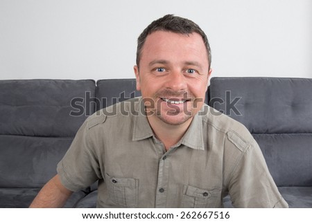 Handsome  man smiling unshaven looking up over white background
