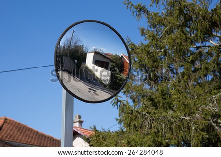 Close up traffic convex mirror near car park entrance
