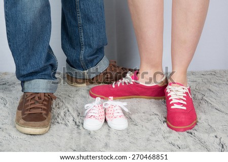 Mother and father with nice shoes and baby shoes