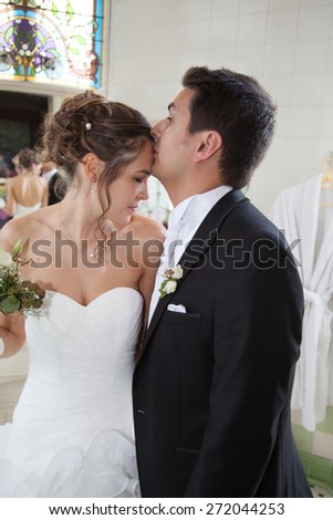 Happy bride and groom on their wedding kissing