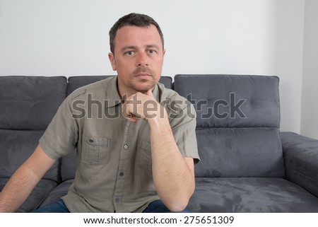 Relaxed  man sitting on sofa in the house