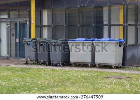 Row of large wheelie bins for rubbish, recycling and garden waste