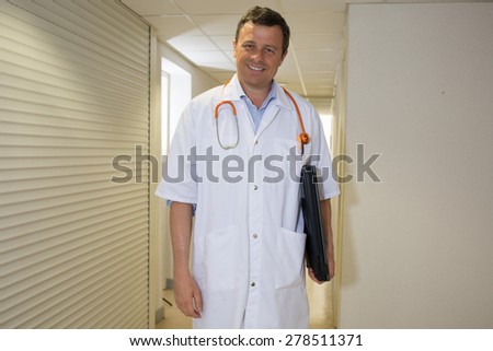 Handsome Doctor at hospital waiting for patient