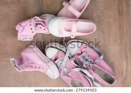 Family shoes on wooden background, family concept