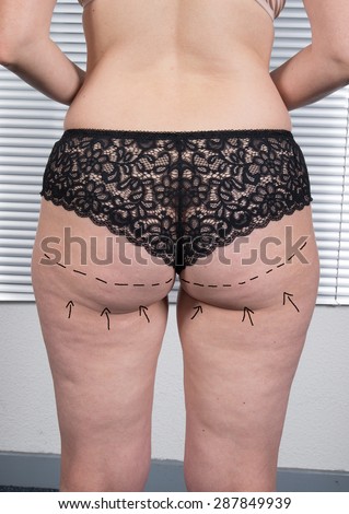 Female body with the drawing arrows on it isolated on black