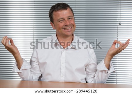 Man at office Tries  to meditate to relax