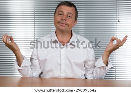 Man at office Tries  to meditate to relax