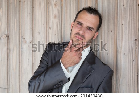 Charming man with a shirt  under wooden background