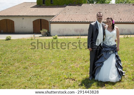 Newlywed couple in  after their wedding looking at the camera