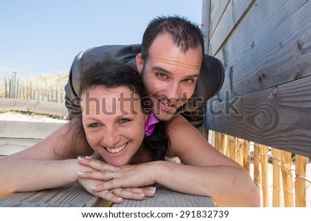 Wedding couple in love at the beach , piggy back