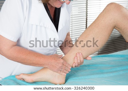 Close up of physiotherapist massaging female foot