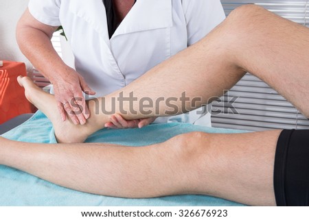 Close up of physiotherapist massaging female foot