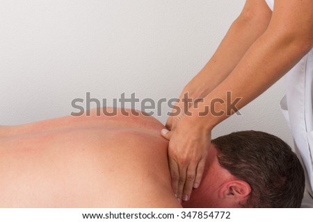 Young and healthy man in spa salon. Traditional Swedish massage therapy and beauty treatments.