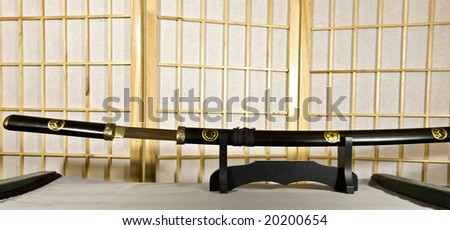 Traditional Japanese samurai sword mounted on special black wooden stand