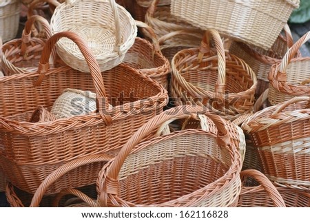 Empty hand made wicker baskets of different styles and colours in a market