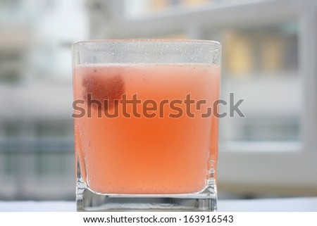 Coloured multi vitamin carbon tablet or effervescent pill making bubbles in a glass of water, in the morning on a window sill