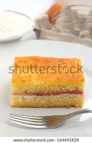 Home made victoria sponge or pound cake, a cake based on wheat flour, sugar, butter or oil and eggs mixed with baking powder with jam and whipped double cream