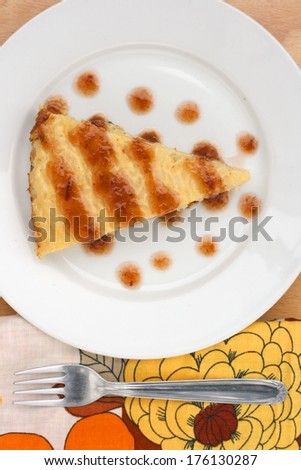 Delicious baked rice pudding, served with hot plum marmalade on a plate with fork