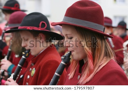 CERKNICA, SLOVENIA - MARCH 2, 2014: A young woman plays clarinet in a brass band at traditional Slovenian carnival called \