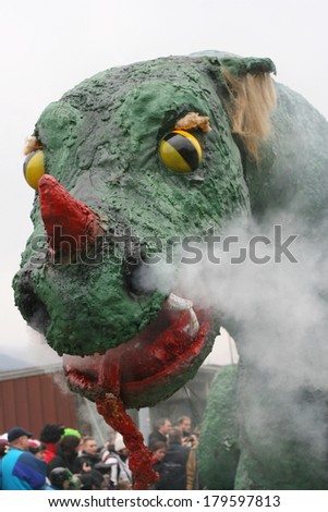 CERKNICA, SLOVENIA - MARCH 2, 2014: Fearsome dragon with smoke and fire at traditional Slovenian carnival called 