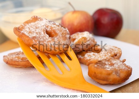 Fried apple in pancake dough or apple fritters with icing sugar and cinnamon