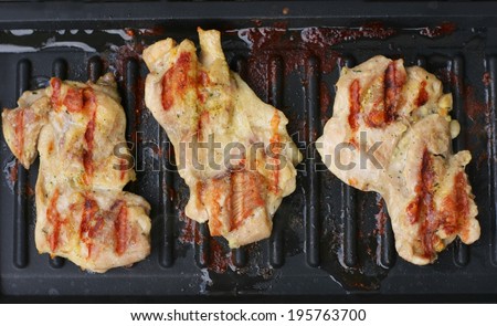 Chicken chicken thighs meat without bone on an electric grill without adding oil, low fat food preparation