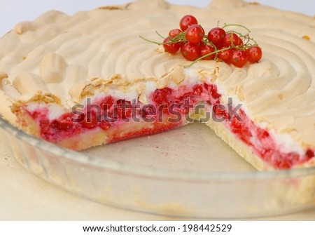 Piece of red currant pie with beaten egg whites and sugar mixture on top
