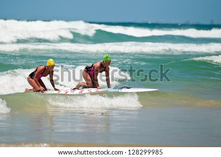 GOLD COAST, SURFERS PARADISE, QLD,  AUSTRALIA - FEB 9. 2013: Two athlete compete in the boarding stage on the round four of the Surf Ironwoman Series on February 09th 2013, Gold Coast Australia.