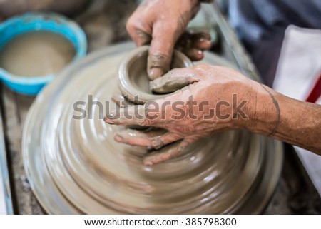 Clay potter creating on the pottery wheel