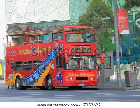 MELBOURNE AUSTRALIA - March 1,2014: Melbourne sightseeing bus parked in front of Fed square -  The world famous hop on, hop off double decker bus is a popular way to see Melbourne.
