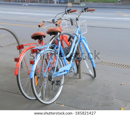 MELBOURNE AUSTRALIA - MARCH 1, 2014: Red and Blue bicycles parked on Swanston Street - The city has an extensive network of off-road bicycle paths, as well as designated bicycle lanes on many streets