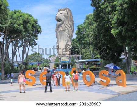 SINGAPORE - 28 May, 2014: Unidentified people take photos of Merlion in Sentosa Island. Sentosa island is a popular island resort featuring Universal studio visited by 5 million people a year.