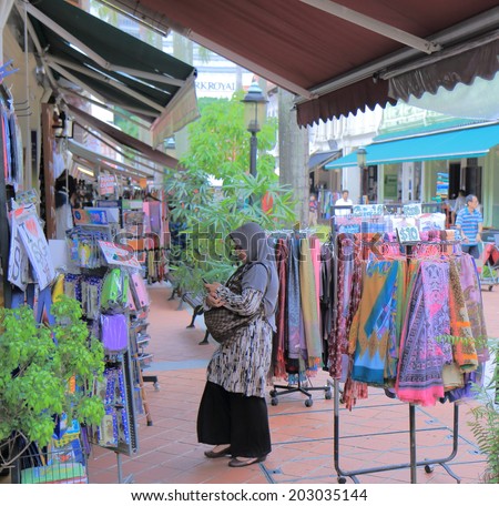 SINGAPORE - 27 May, 2014: Unidentified woman shops at clothes shop in Arab Street. Arab Street is the Kampong Glam neighbourhood famous for independent fashion and Middle Eastern cafes.