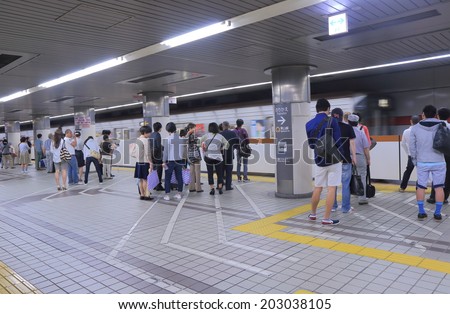 NAGOYA JAPAN - 31 MAY, 2014:Unidentified people wait for subway at Nagoya subway station. The Nagoya subway system covers 93.3km of route, serving 87 stations.