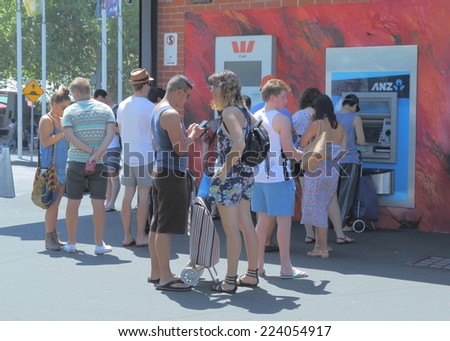 MELBOURNE AUSTRALIA - FEBRUARY 2, 2014: Unidentified people queue for ATM - More than 30,000 ATMs available across Australia.