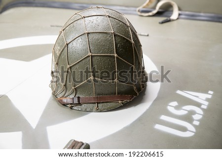 military helmet on the hood of military vehicle with with star