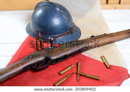 french military helmet of the First World War with a gun on a red white blue flag