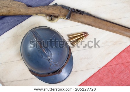 french military helmet of the First World War with a gun on a blue white red flag