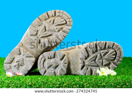 soles of hiking boots in the grass
