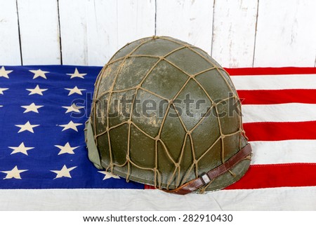 wwii military helmet on american flag