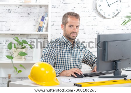 young engineer working on his computer in his office